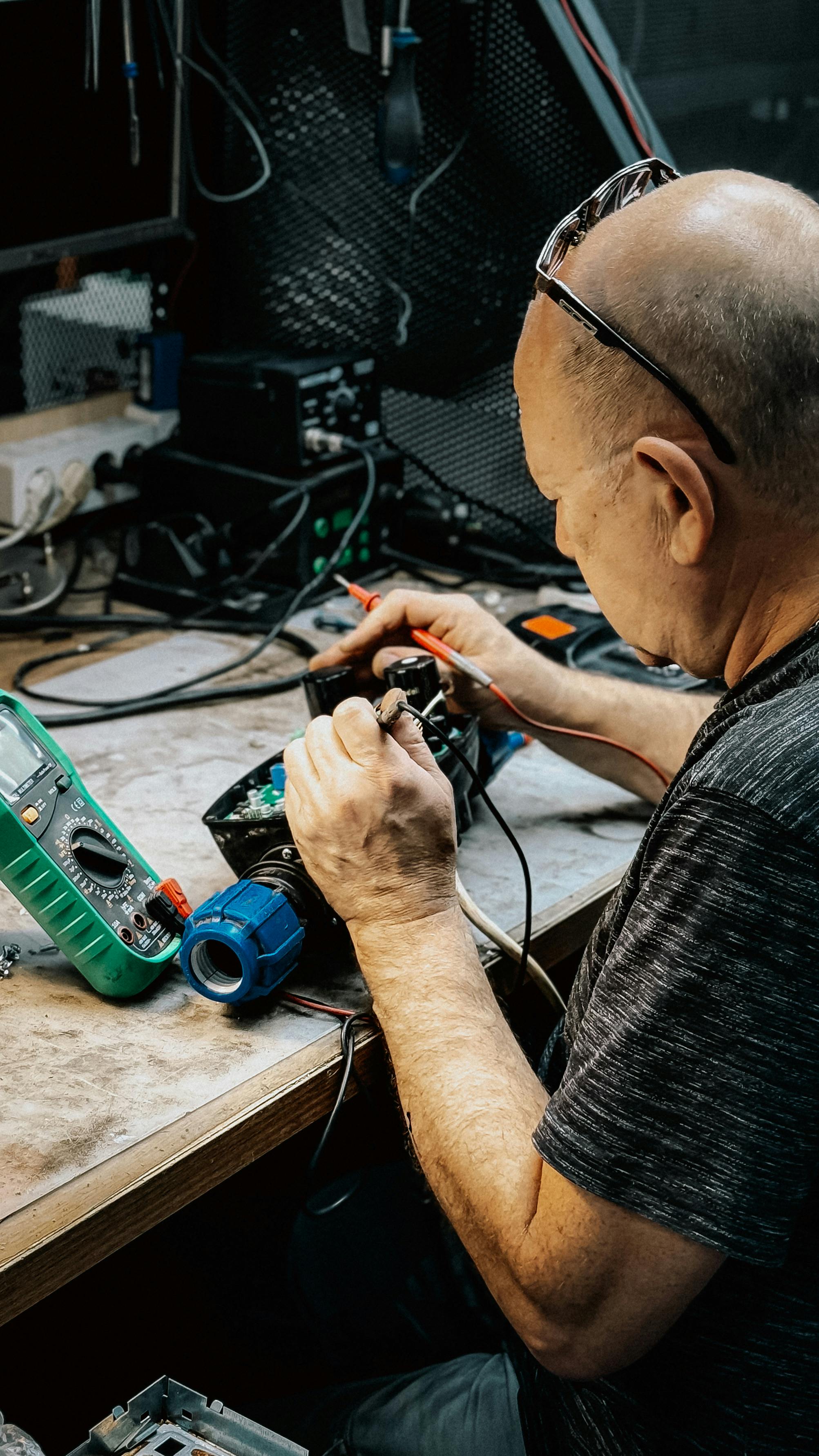 A learner working on appliance repairs at a workshop